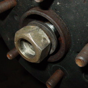 Do so by removing the big nut on the end and sliding out the axle.