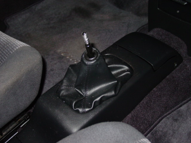 Once the shift knob is off, you will need to remove the center console. 