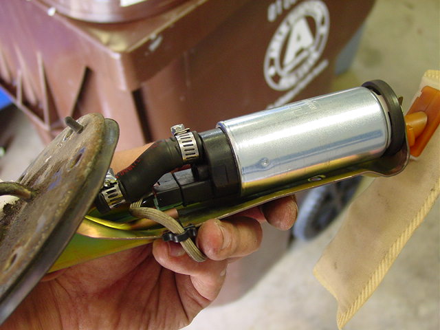 Attach the rubber hose to the pump, place the rubber ring on the bottom, and slip it into the bracket by attaching the hose first, then sliding the bottom end into the bracket. 