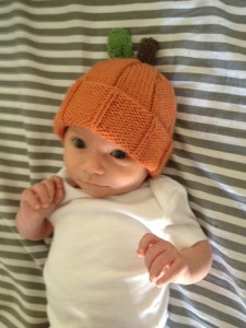 Arya and the pumpkin hat that Aunt Dana made for her.