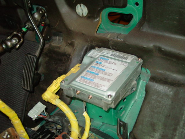 This is the ideal time to remove the airbag harness and computer. The computer is located in the center of the car near the firewall. You will need a torx bit to remove the computer.