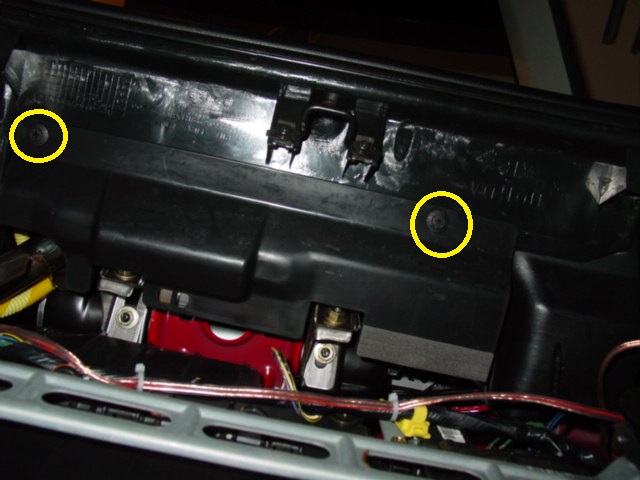 Looking under the dash, where the glove box used to be, you will see a cover held in by two plastic screws. Remove these screws to gain access to the airbag wiring and mounting bolts.