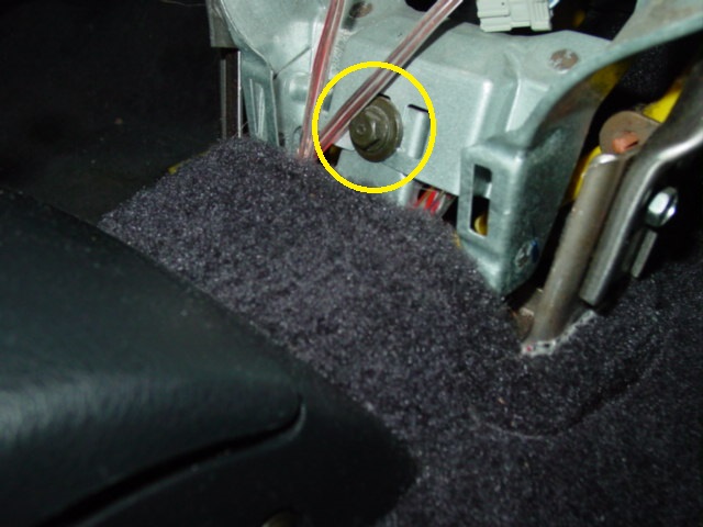 Remove the single bolt found near the floor behind the console that was removed earlier.