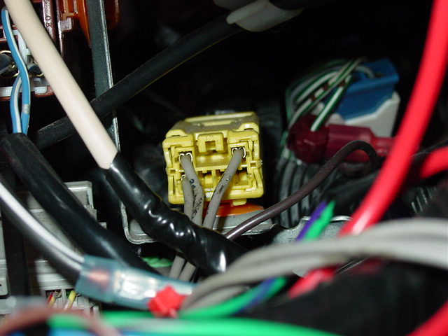 The yellow airbag harness attaches to a plug found on top of the fuse panel.