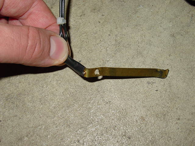 Leave slack for the horn wire. Solder this wire to a strip of 1/4" brass stock. The brass strip should be bent and drilled as shown.